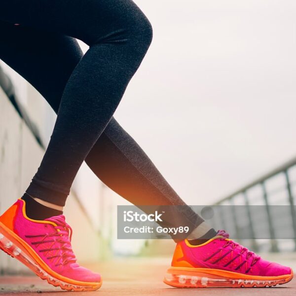 fitness, sport, training, people and lifestyle concept- Women legs with shoe and sun